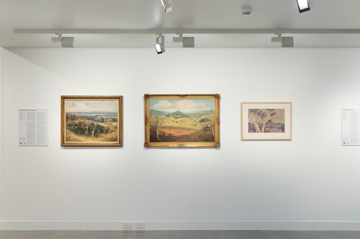 Arthur Boyd, 'Landscape near Berwick', 1948, National Gallery of Australia, Canberra, purchased 1959 © Estate of Arthur Boyd; Jan Morgan, 'Rolling Hills of Dundowran', 1977; and Keith Namatjira, 'Untitled', circa. 1970. Photo: Natasha Harth.