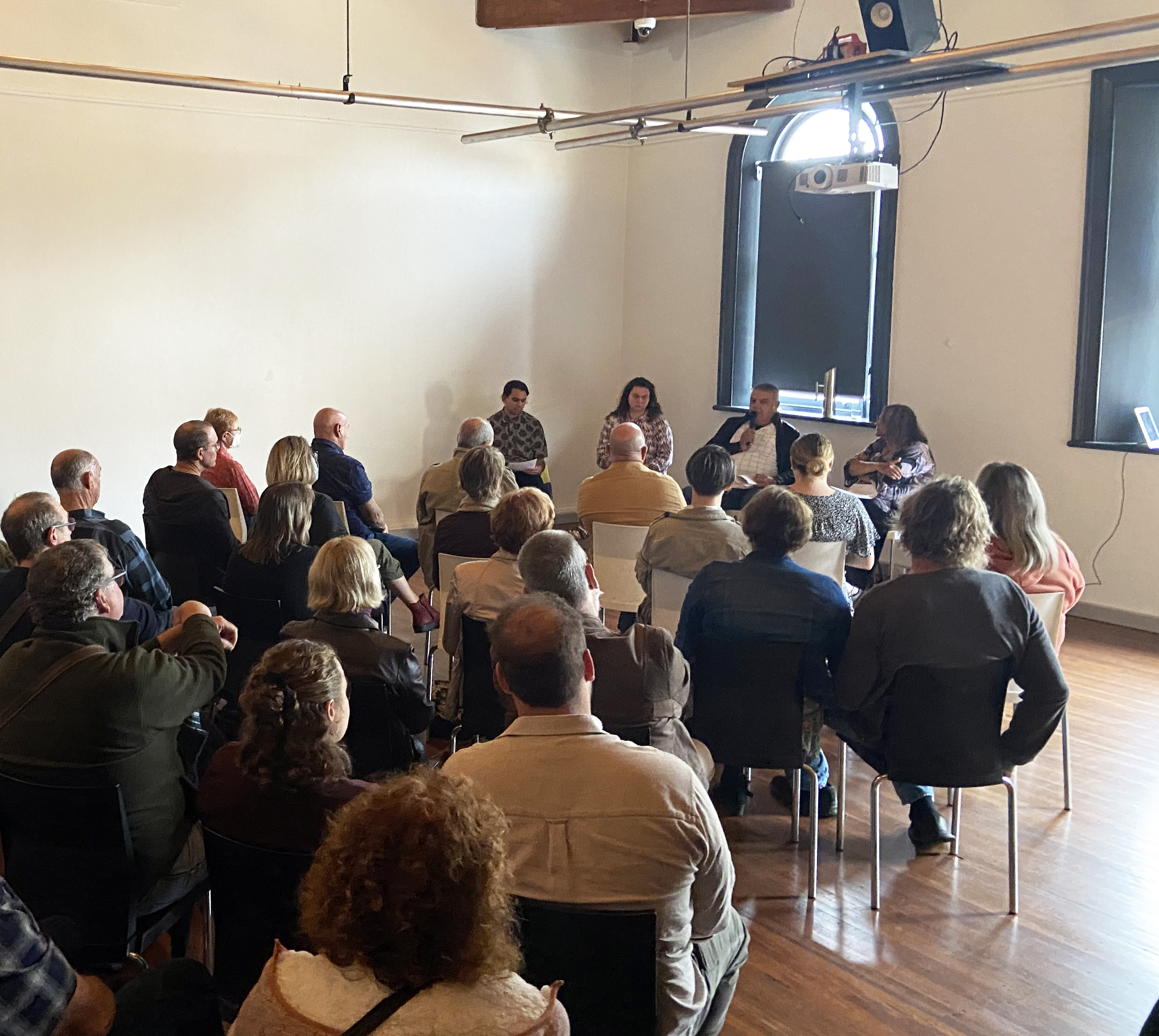 A crowd watches a panel discuss Land Rights and Native Title at Gatakers Creative Space. Photo: Sarah Thomson.