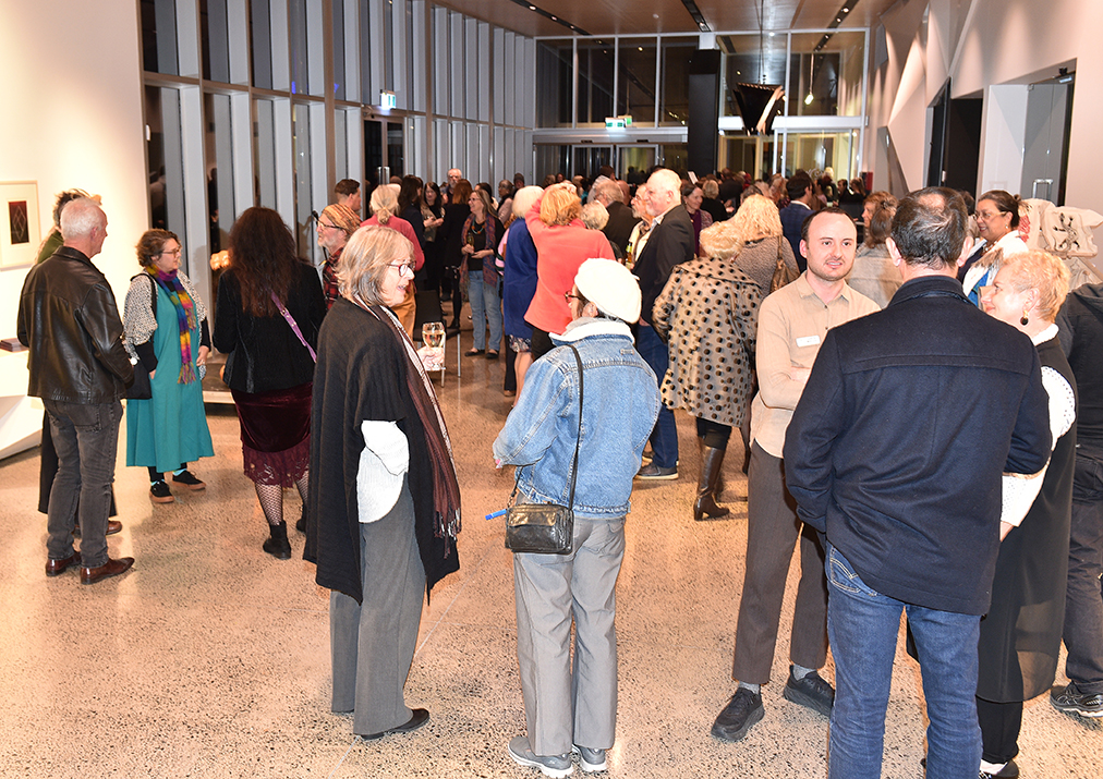 Guests gather in the Hervey Bay Regional Gallery for the exhibition opening.